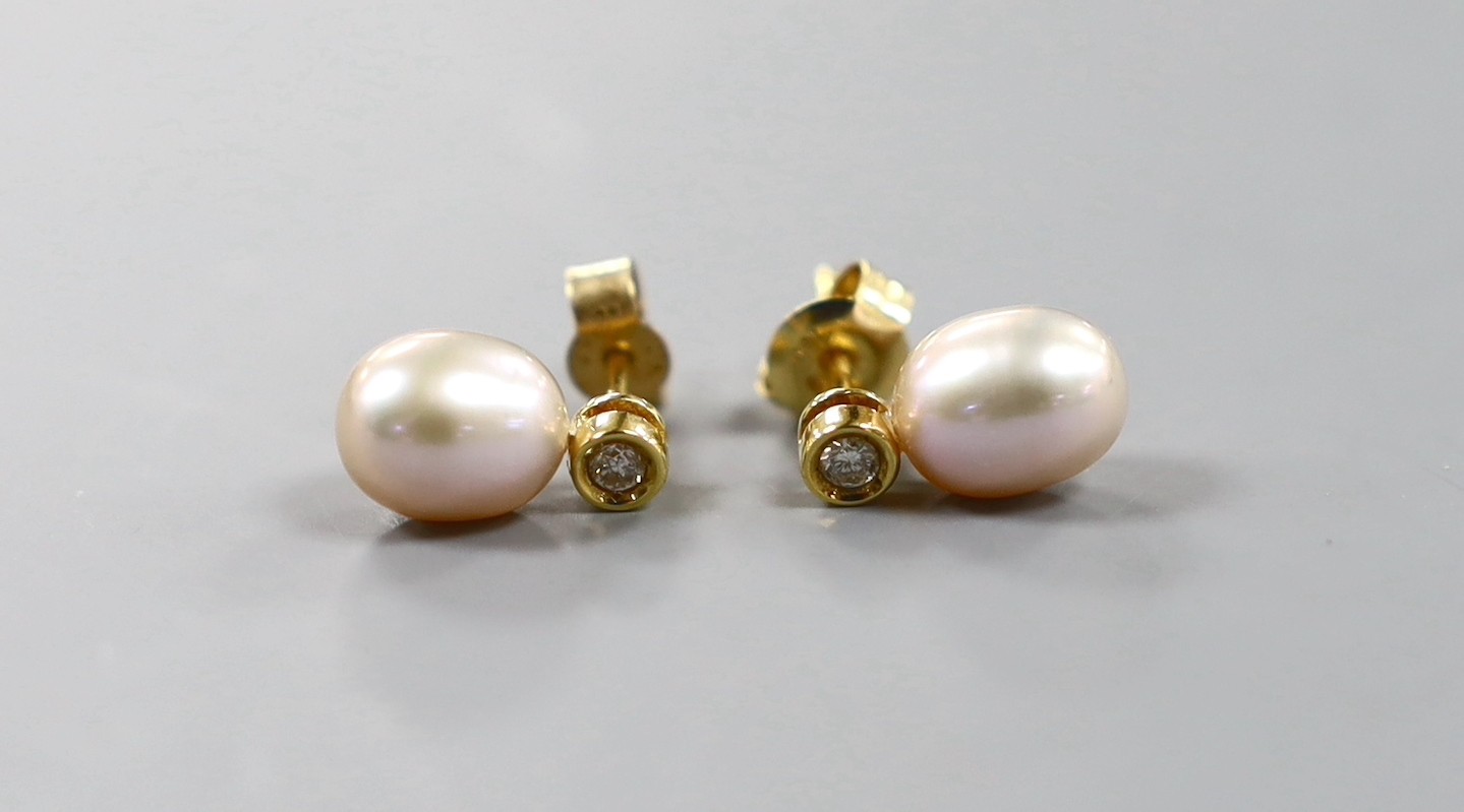 A modern pair of 18ct gold, cultured pearl and diamond set ear studs, 12mm, gross weight 2.3 grams.